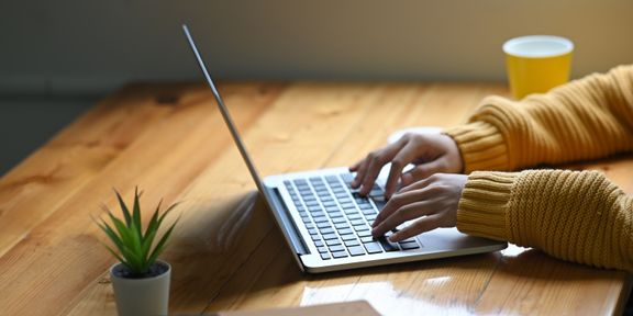 Typing on a laptop